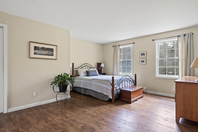 bedroom with wood finished floors and baseboards