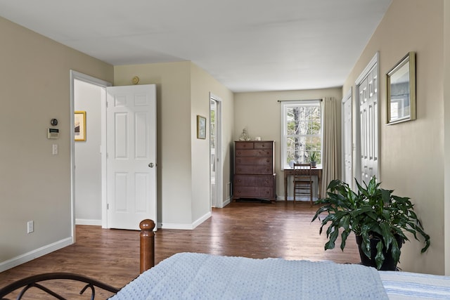 bedroom featuring wood finished floors and baseboards