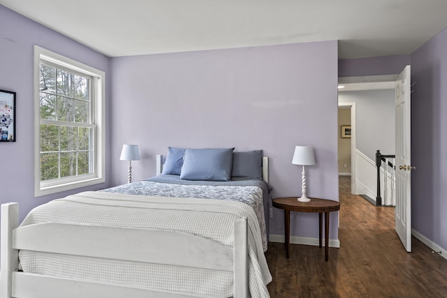 bedroom featuring wood finished floors and baseboards