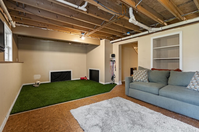 carpeted living area with golf simulator and baseboards