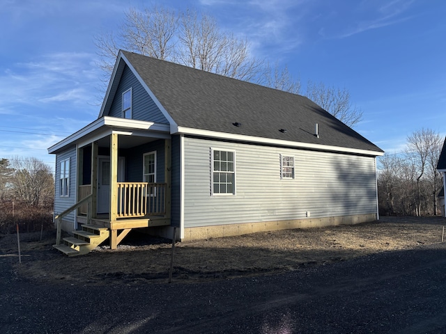 view of property exterior featuring a shingled roof