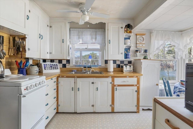 148 Anglers Rd, Windham, ME 04062 - kitchen with white cabinets, light floors, electric stove, a ceiling fan, and a sink