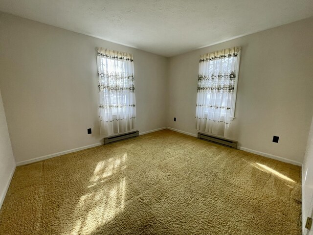 17 Greenfield Ln, Biddeford, ME 04005 - unfurnished room with baseboards, carpet floors, and a baseboard radiator