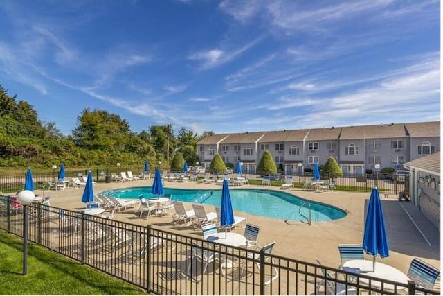 pool featuring fence and a patio