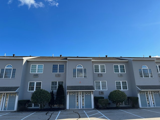 view of building exterior featuring uncovered parking