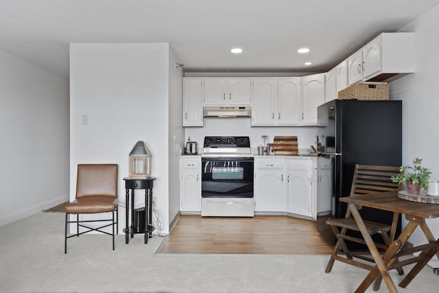 kitchen with recessed lighting, under cabinet range hood, freestanding refrigerator, electric range, and white cabinetry