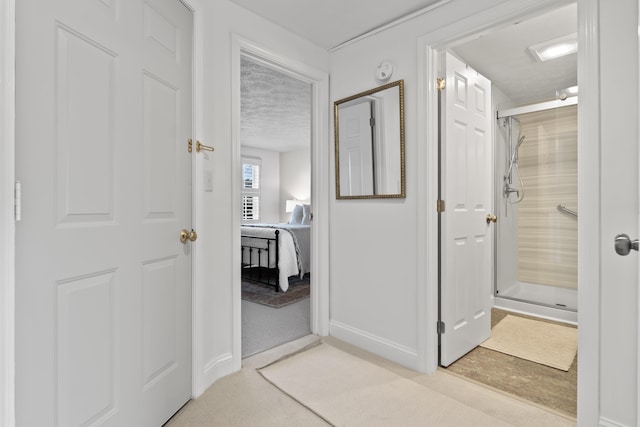 full bath featuring walk in shower, baseboards, a textured ceiling, and ensuite bathroom