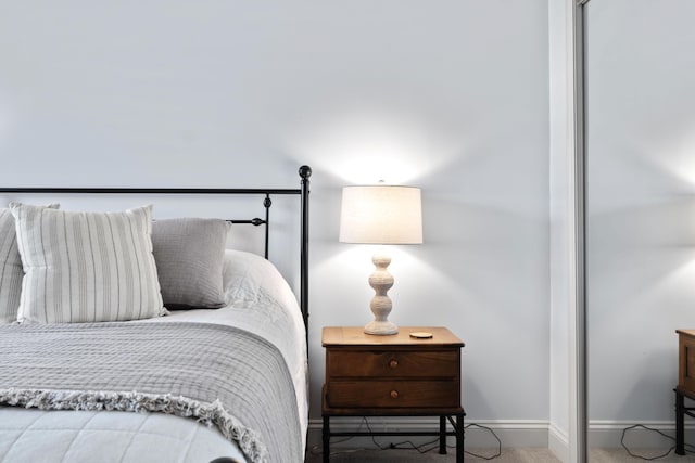 bedroom featuring baseboards and carpet