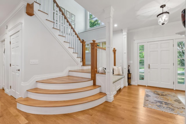 184 Spruce Point Rd, Yarmouth, ME 04096 - foyer entrance featuring light wood-style flooring, ornamental molding, stairway, and a healthy amount of sunlight