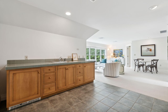 184 Spruce Point Rd, Yarmouth, ME 04096 - kitchen with tile countertops, open floor plan, a sink, and visible vents
