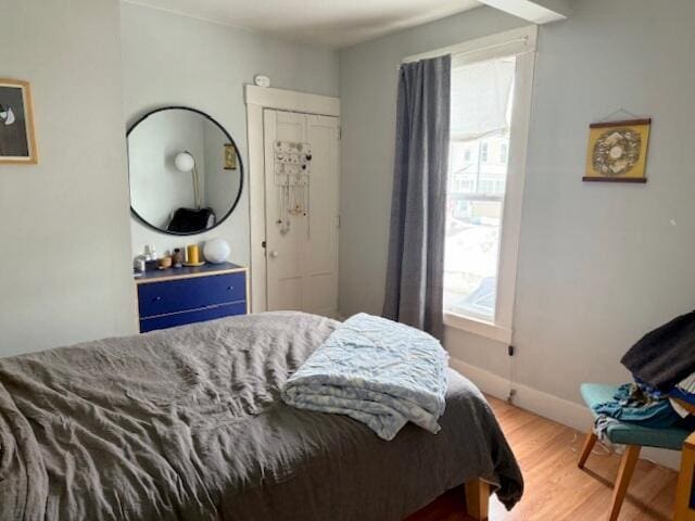 bedroom featuring baseboards and wood finished floors