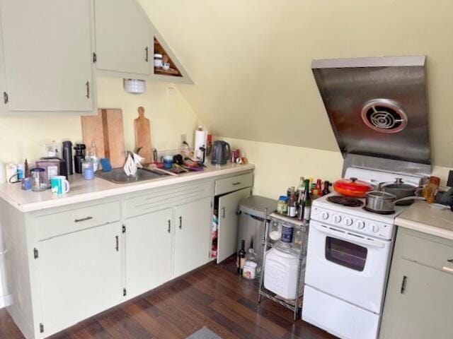 kitchen featuring light countertops, white cabinets, dark wood-style floors, and electric range