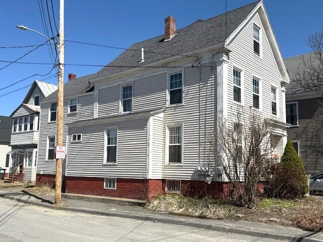 view of property exterior with a chimney