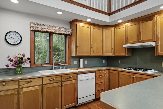 175 Quail Run Rd, Bristol, ME 04539 - kitchen with a sink, white appliances, under cabinet range hood, brown cabinets, and recessed lighting