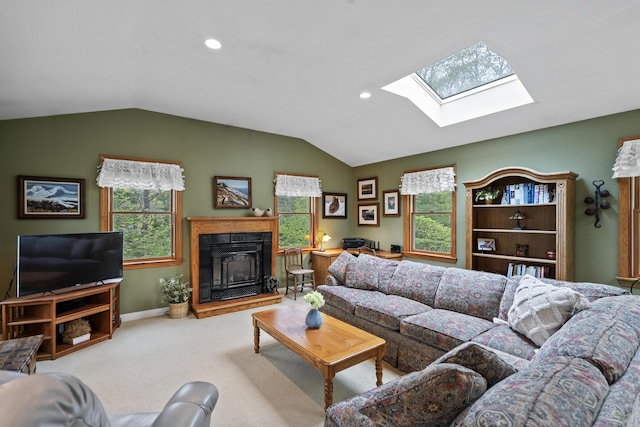 175 Quail Run Rd, Bristol, ME 04539 - living room with lofted ceiling, a skylight, carpet flooring, a fireplace with raised hearth, and healthy amount of natural light