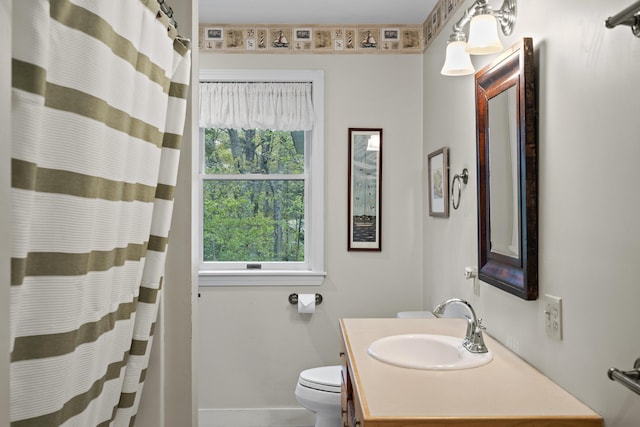 175 Quail Run Rd, Bristol, ME 04539 - bathroom featuring toilet, vanity, baseboards, and a shower with shower curtain