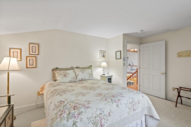 175 Quail Run Rd, Bristol, ME 04539 - bedroom featuring baseboards, lofted ceiling, and light colored carpet