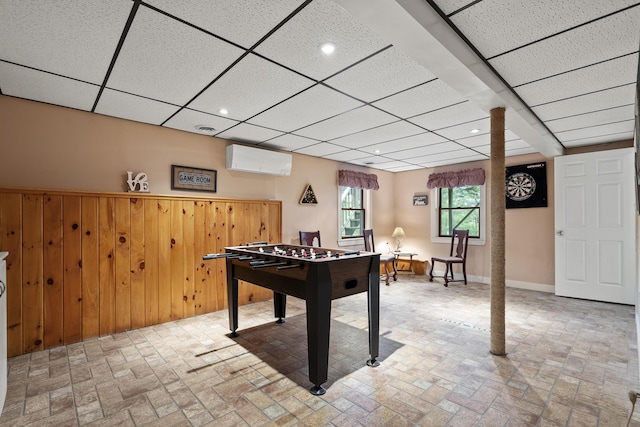175 Quail Run Rd, Bristol, ME 04539 - recreation room with brick patterned floors, a wall mounted AC, a drop ceiling, wood walls, and recessed lighting