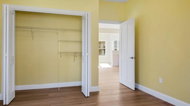 LOT16 Beech St Unit 16, Hallowell, ME 04347 - unfurnished bedroom with baseboards, wood finished floors, and a closet
