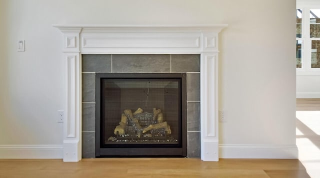 LOT16 Beech St Unit 16, Hallowell, ME 04347 - room details with baseboards, a tiled fireplace, and wood finished floors