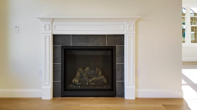 LOT16 Beech St Unit 16, Hallowell, ME 04347 - interior details with wood finished floors, a tiled fireplace, and baseboards