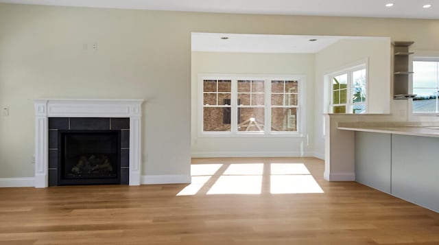 LOT16 Beech St Unit 16, Hallowell, ME 04347 - unfurnished living room with baseboards, light wood-style floors, and a tiled fireplace