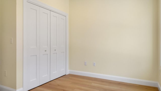 LOT16 Beech St Unit 16, Hallowell, ME 04347 - unfurnished bedroom with baseboards, light wood-style floors, and a closet