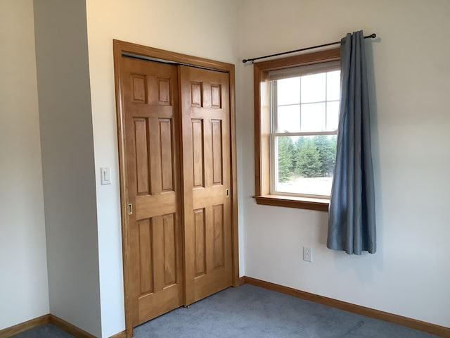 interior space featuring carpet floors and baseboards