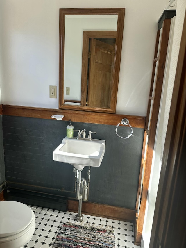 bathroom featuring tile patterned floors, a sink, and toilet