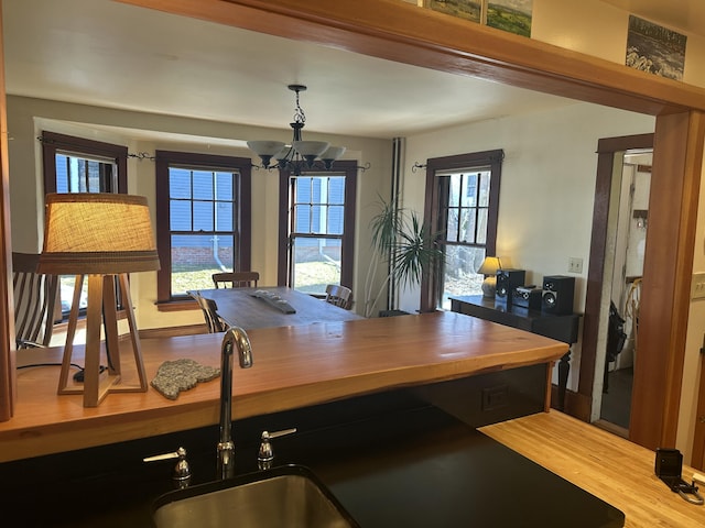 dining room featuring wood finished floors and a chandelier