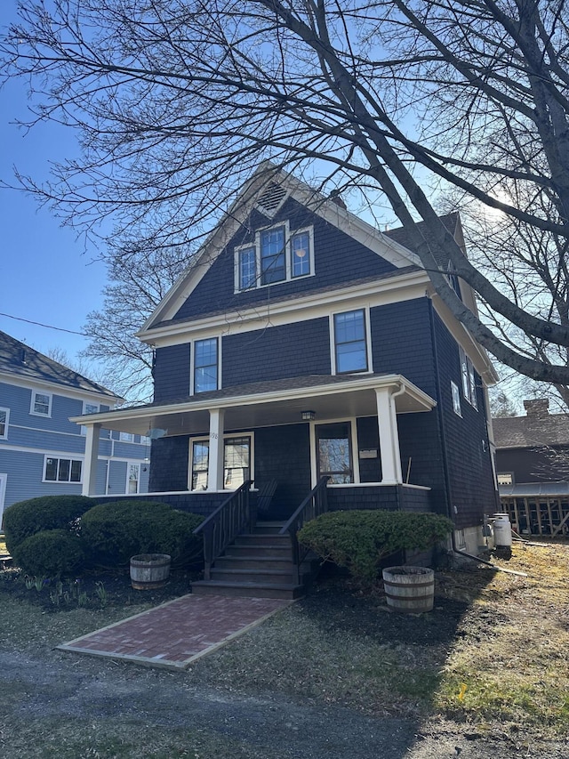 american foursquare style home featuring a porch