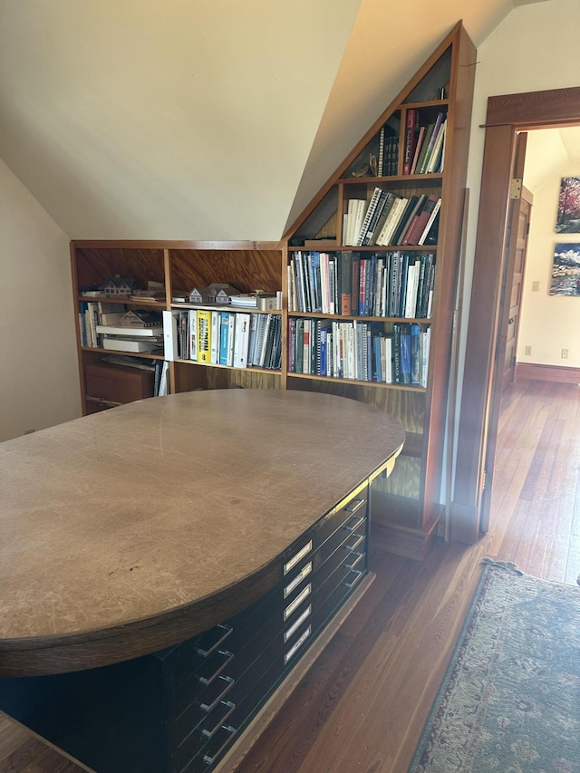 interior space featuring lofted ceiling and wood finished floors