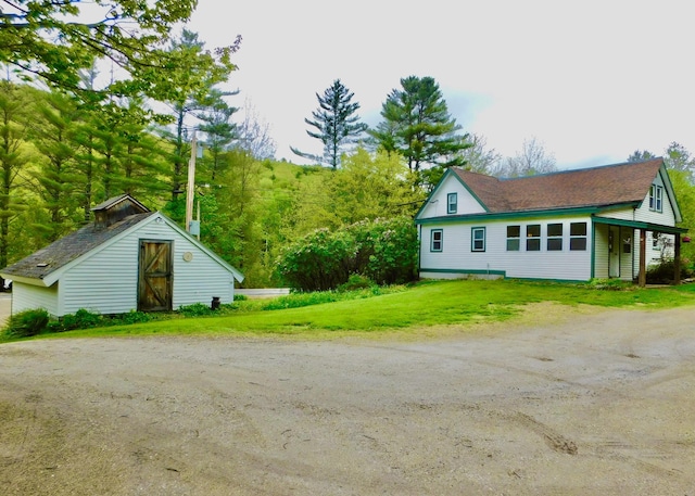 346 Bear River Rd, Newry, ME 04261 - view of side of property with driveway, a storage shed, and a lawn