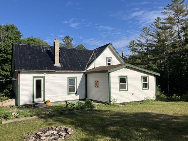 346 Bear River Rd, Newry, ME 04261 - back of house featuring a chimney, a lawn, a fire pit, and a metal roof