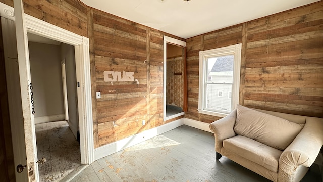 11 Maple St, Milo, ME 04463 - living area with wooden walls, baseboards, and wood finished floors