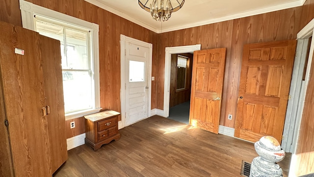 11 Maple St, Milo, ME 04463 - foyer entrance with a chandelier, baseboards, dark wood finished floors, and wooden walls