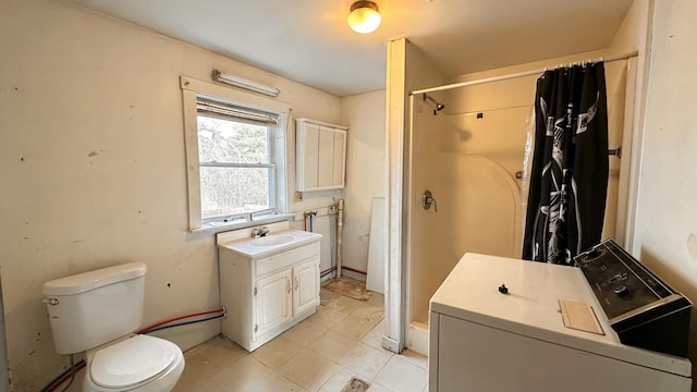 11 Maple St, Milo, ME 04463 - bathroom featuring washer / dryer, a shower, vanity, toilet, and tile patterned flooring