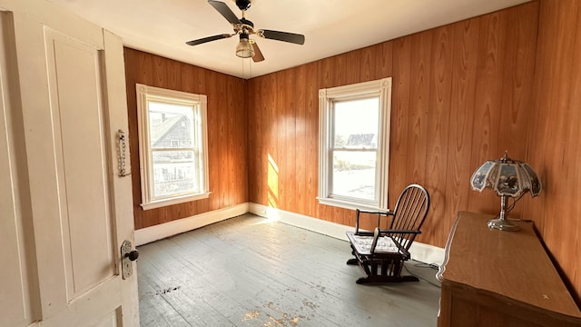 11 Maple St, Milo, ME 04463 - unfurnished room featuring plenty of natural light, hardwood / wood-style flooring, a ceiling fan, and baseboards