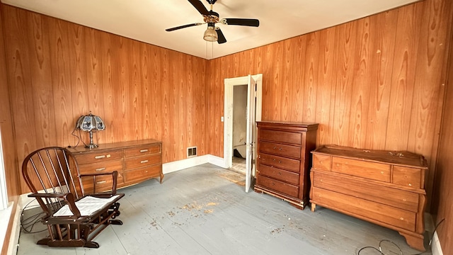 11 Maple St, Milo, ME 04463 - living area with a ceiling fan, wood finished floors, and wooden walls