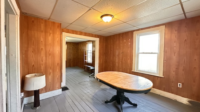 11 Maple St, Milo, ME 04463 - dining room with wood-type flooring, a drop ceiling, and wood walls