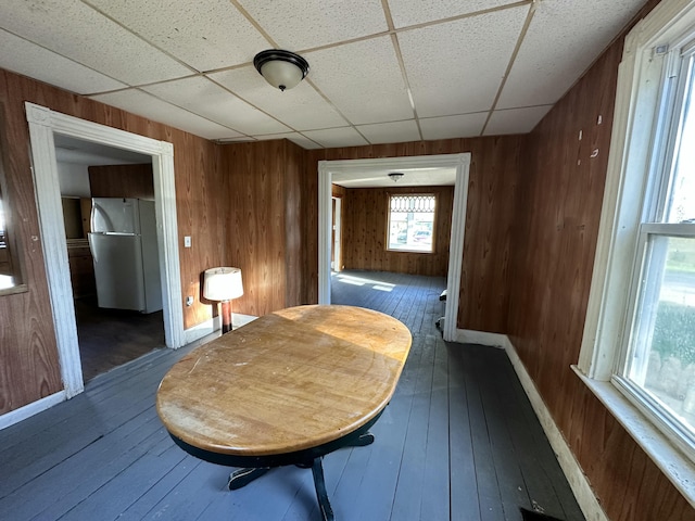 11 Maple St, Milo, ME 04463 - hallway featuring a drop ceiling, wooden walls, hardwood / wood-style floors, and baseboards