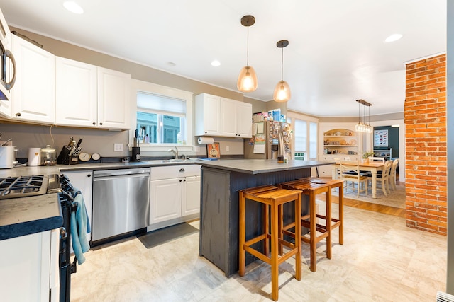 1 Silver Ter, Waterville, ME 04901 - kitchen featuring white cabinets, appliances with stainless steel finishes, a sink, a center island, and a kitchen bar