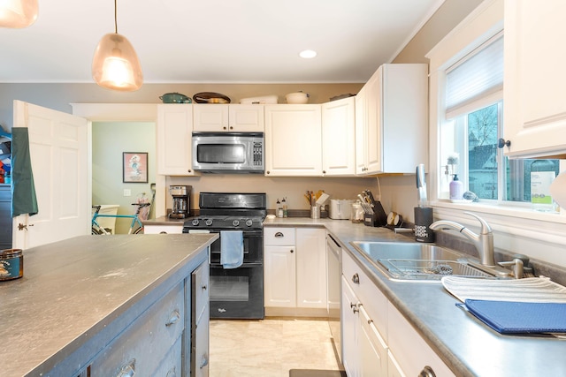 1 Silver Ter, Waterville, ME 04901 - kitchen with white cabinets, stainless steel appliances, hanging light fixtures, and a sink