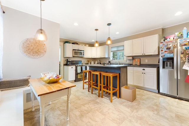 1 Silver Ter, Waterville, ME 04901 - kitchen with white cabinets, dark countertops, appliances with stainless steel finishes, and a breakfast bar