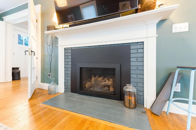 1 Silver Ter, Waterville, ME 04901 - details featuring a brick fireplace, baseboards, and wood finished floors