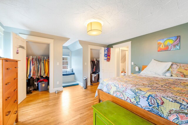 1 Silver Ter, Waterville, ME 04901 - bedroom with a walk in closet, baseboards, a closet, connected bathroom, and light wood-style floors
