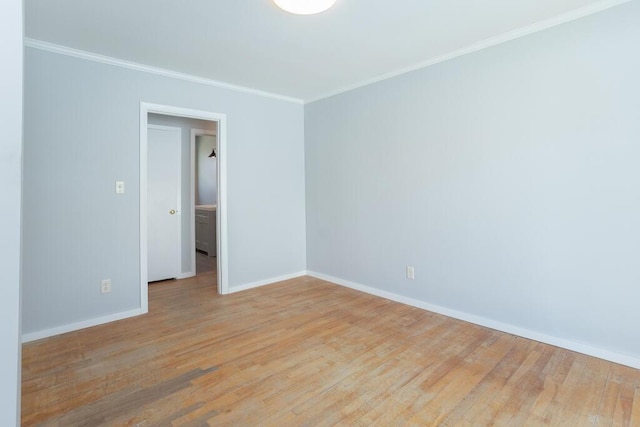 empty room featuring baseboards, ornamental molding, and light wood-style flooring