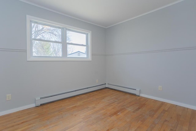 spare room featuring a baseboard radiator, baseboards, ornamental molding, and light wood finished floors