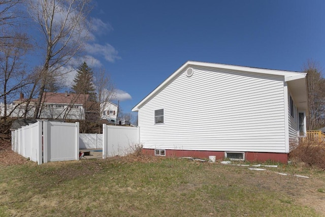 view of side of property featuring a yard and fence