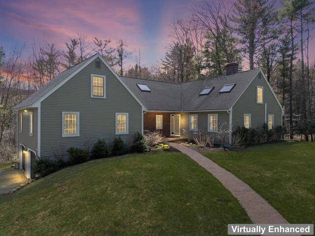 view of front of property with a chimney, a garage, a shingled roof, and a front yard